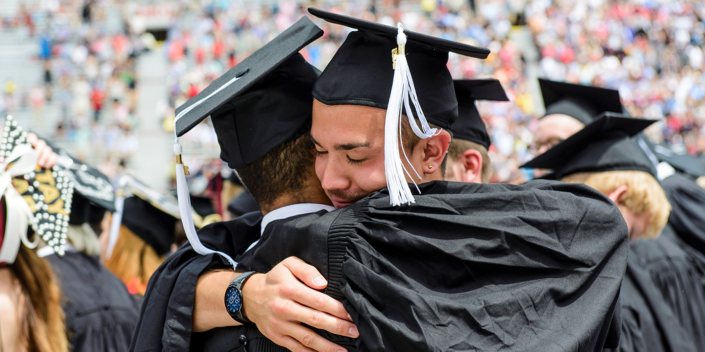 Graduating students hugging