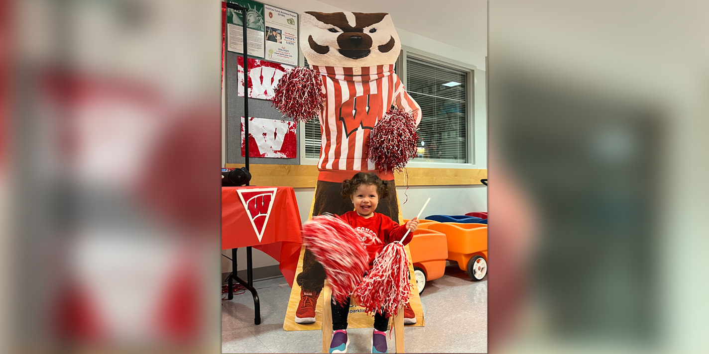 Smiling child with a cut-out of Bucky